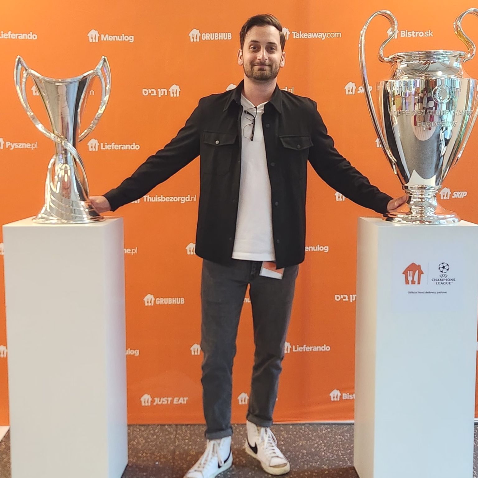 Daniel Listi with UEFA Champions League trophies at Just Eat Takeaway